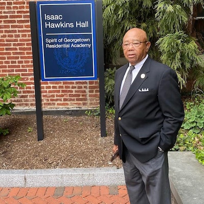 Joseph Stewart standing in front of Isaac Hawkins Hall at Georgetown University, named after his ancestor.